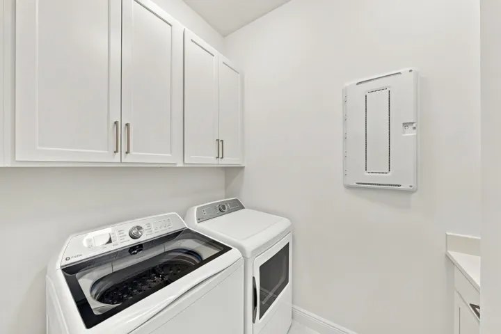 Laundry room upgraded washer and dryer with upgraded cabinets