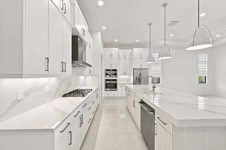 Satin nickel finishes with upgraded quartz countertops and backsplash