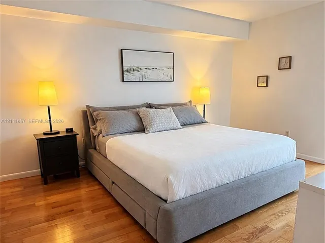 Room featuring wood-finish flooring and a recessed ceiling design