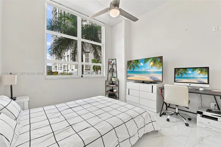 Large pane window featuring natural light, polished tile flooring, and a ceiling-mounted light fixture with fan blades