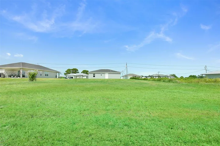 Expansive open lot featuring level grass terrain and clear horizon lines