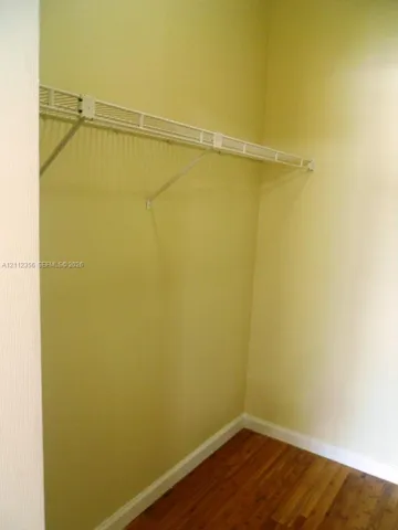 Storage area featuring wood-finish flooring and an integrated wire shelving system