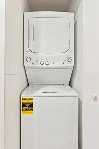 Stackable white laundry unit featuring a top-loading washer and front-loading dryer enclosed within a recessed alcove