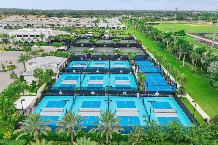 Multiple pickleball courts featuring perimeter fencing, integrated lighting, and professional-grade surfacing
