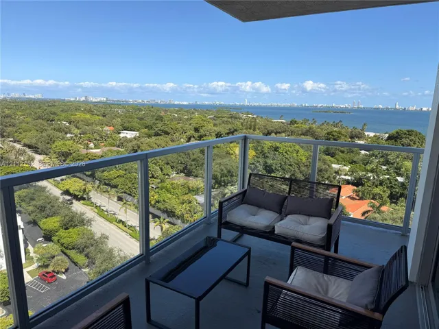 Private balcony featuring glass panel railings and expansive overhead coverage