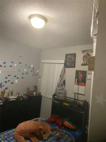 Room featuring a ceiling-mounted dome light fixture and horizontal slat blinds