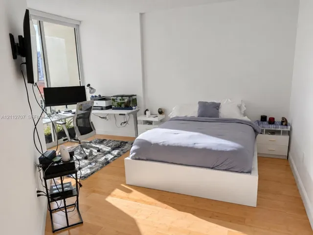 Interior space featuring floor-to-ceiling glass paneling and wood-finish flooring