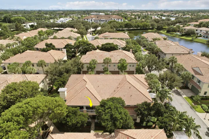 Aerial perspective of multi-story residence featuring a tile roof and a covered balcony