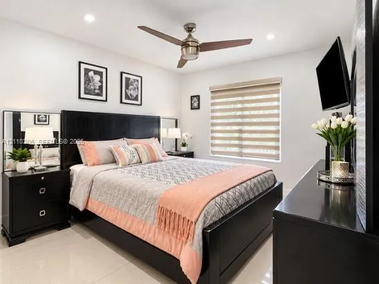 Neutral wall finish with recessed lighting, tile flooring, and a ceiling fan with integrated lighting