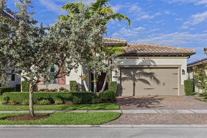 Delightful exterior featuring manicured landscape and tiled driveway.