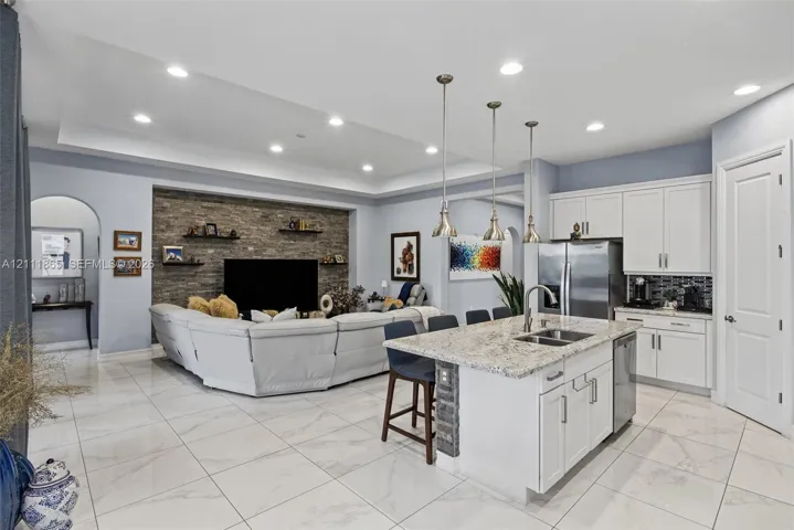 Broad open concept view - notice high vaulted ceilings, sunken lights and elegant 24 x 24 tiles.