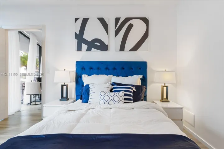 Room featuring white interior wall paint and wood-finish flooring