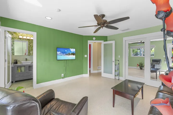Interior room featuring recessed lighting, a ceiling fan, light-colored flooring, and interior doors with frosted glass inserts