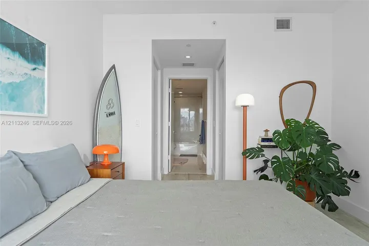 Neutral interior space featuring recessed ceiling lighting, crisp white wall finishes, and light-toned flooring