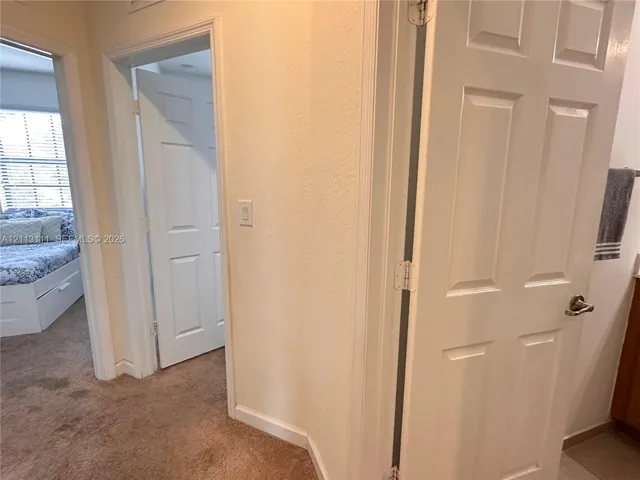 Textured wall finishes, interior six-panel doors, and wall-to-wall carpeting