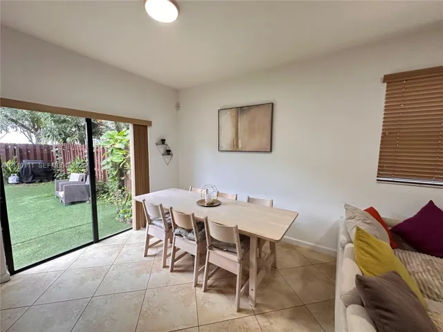 Tile flooring, sliding glass door, and wooden window blinds