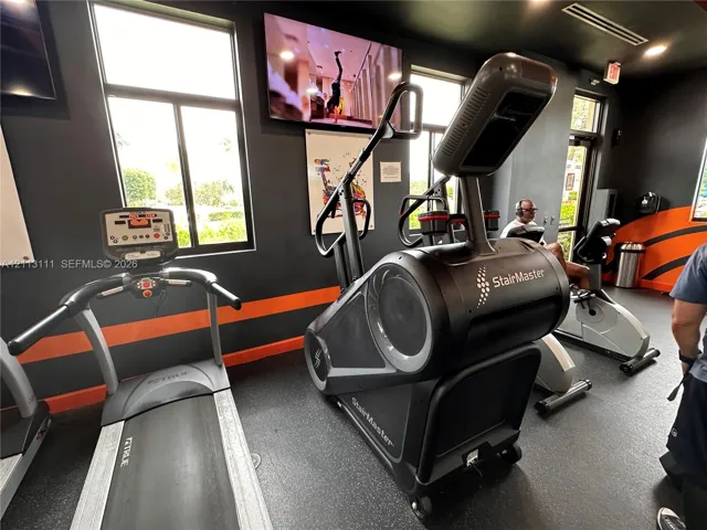 Fitness center featuring large windows, recessed lighting, and durable rubberized flooring
