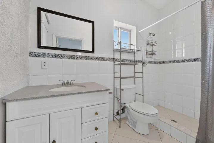 Full bath located at the back of the garage
