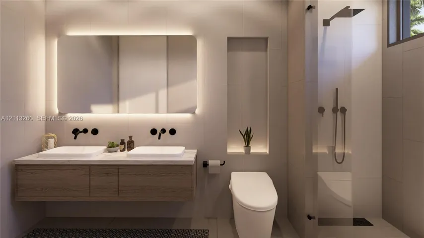 Floating dual-sink vanity with matte black wall-mounted faucets, large LED-backlit mirror, recessed wall niche, and glass-enclosed shower with matte black rainfall showerhead