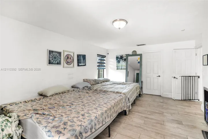 Neutral-toned tile flooring, flush-mount ceiling lighting, and solid-core interior doors
