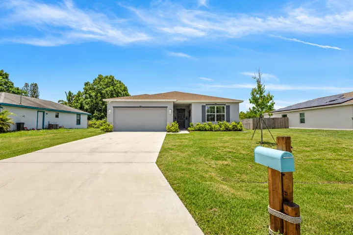 Sunny Gray Ranch Home with Aqua Mailbox