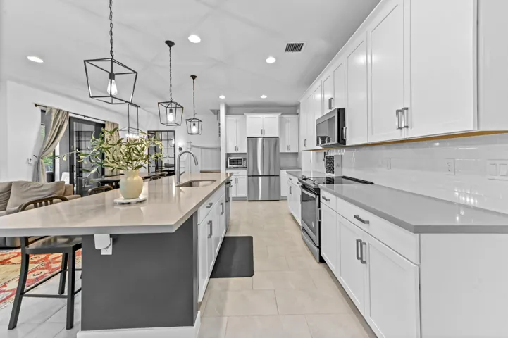 Gourmet kitchen with stainless steel appliances and quartz counters
