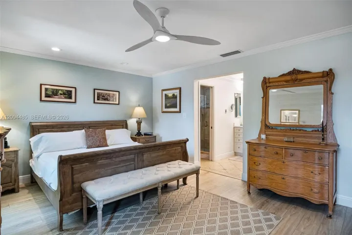 Spacious room featuring wood-finish flooring, recessed lighting, and a modern three-blade ceiling fan