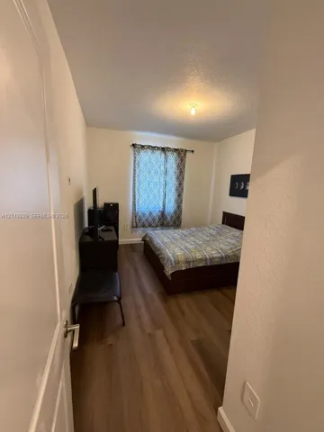 Room featuring wood-finish flooring and a single window