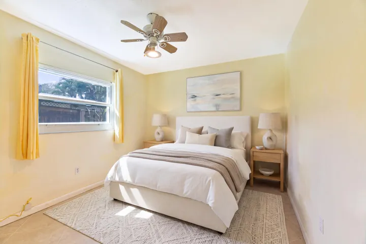 Virtually Staged, tiled flooring, horizontal sliding window, and a central ceiling fan with integrated lighting