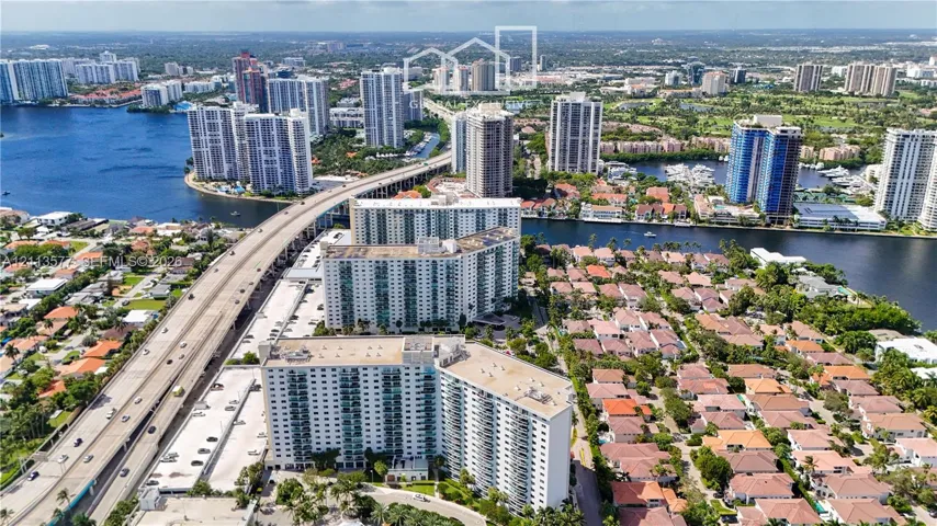 Aerial perspective featuring high-rise residential buildings situated along a waterway