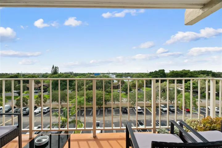 Covered balcony featuring metal railing and tile flooring
