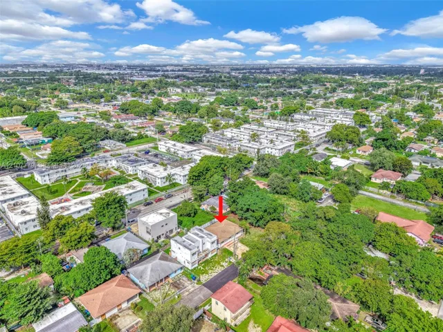 Aerial perspective of a detached residential property situated on a lot with mature trees and established landscaping