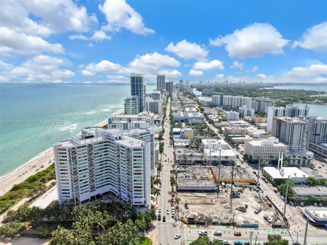 Aerial perspective of coastal high-rise development featuring direct oceanfront exposure, expansive shoreline, and proximity to metropolitan infrastructure