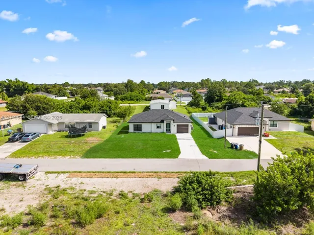 Single-story residence featuring a hipped roof, attached one-car garage, concrete driveway, and a manicured lawn