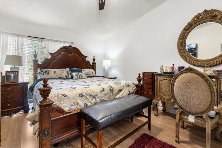 Wood-finish flooring, ceiling fan, and window blinds