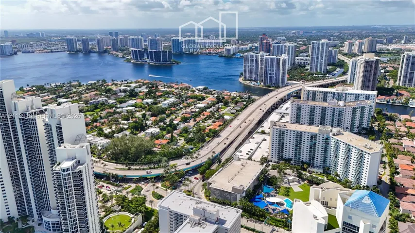 Aerial perspective showcasing waterfront proximity, coastal high-rise architecture, and expansive urban density