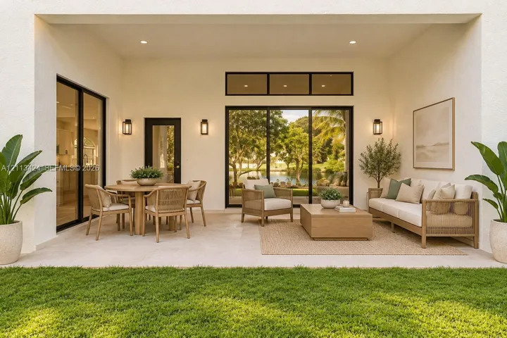 virtually staged Covered patio featuring stone-finish flooring, multi-panel sliding glass doors, transom windows, and wall-mounted exterior lighting
