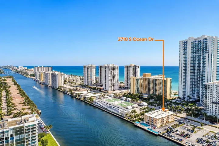 Waterfront property featuring a canal-side location, an outdoor swimming pool, and proximity to the coastline