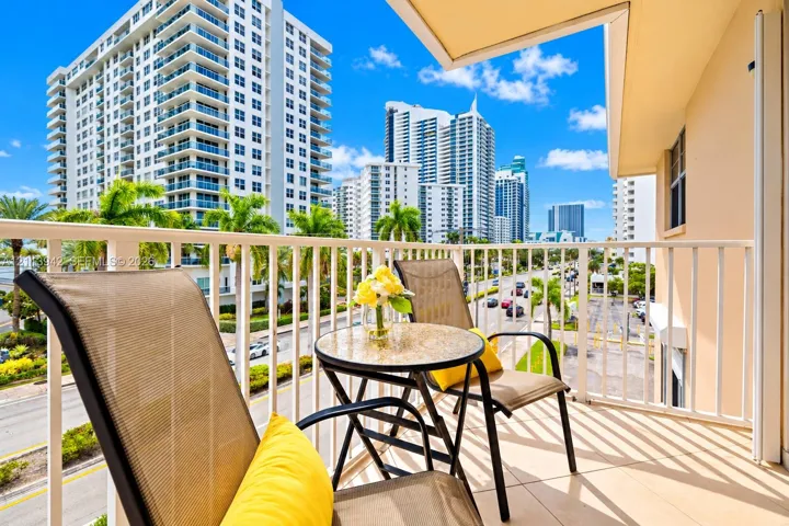 Private balcony featuring tile flooring and a white vertical railing