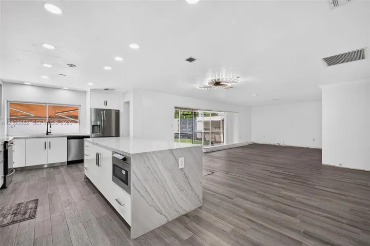 Open-concept interior featuring vinyl wood-plank flooring *