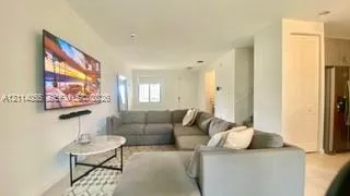 Open-concept interior featuring light-toned flooring, recessed lighting, and a neutral color palette