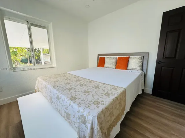Wood-finish flooring, dual-pane window, and solid core door with matte black hardware
