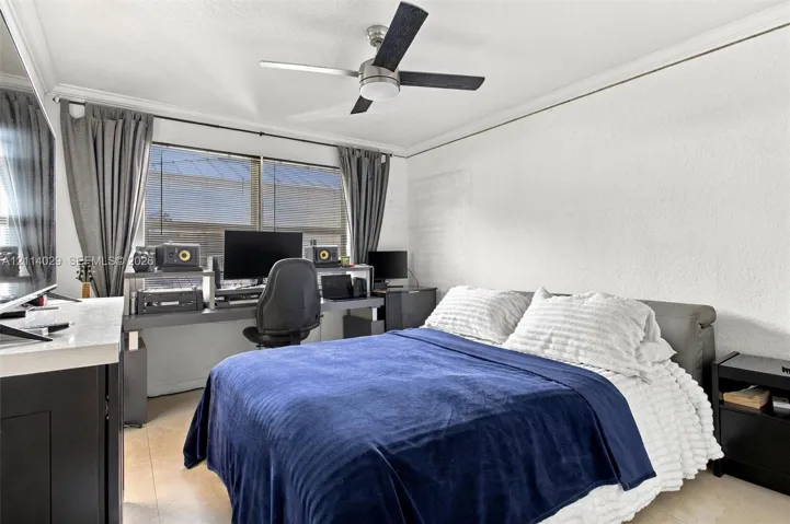 Room featuring a ceiling fan with integrated lighting, large windows, crown molding, and tile flooring