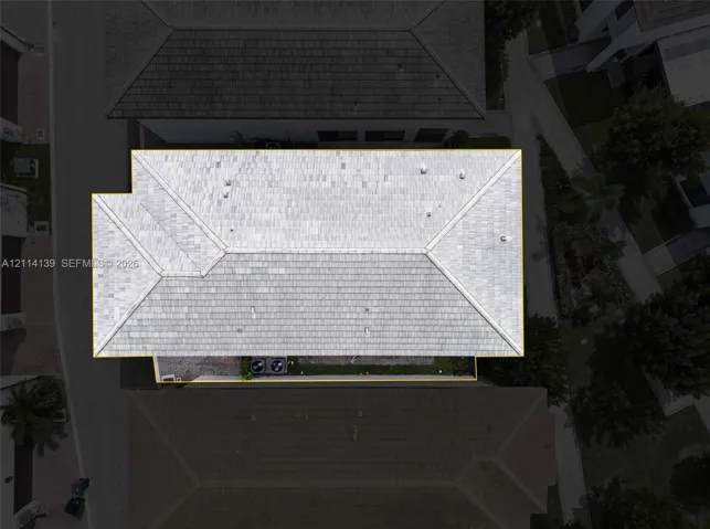 Aerial perspective of a multi-faceted roof structure featuring light-toned tile finish and external HVAC equipment