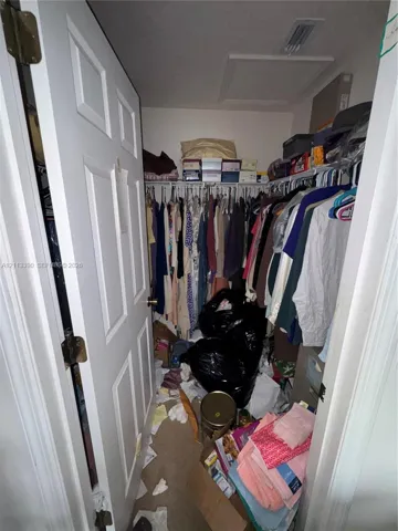 Storage area featuring white panel door and wire shelving