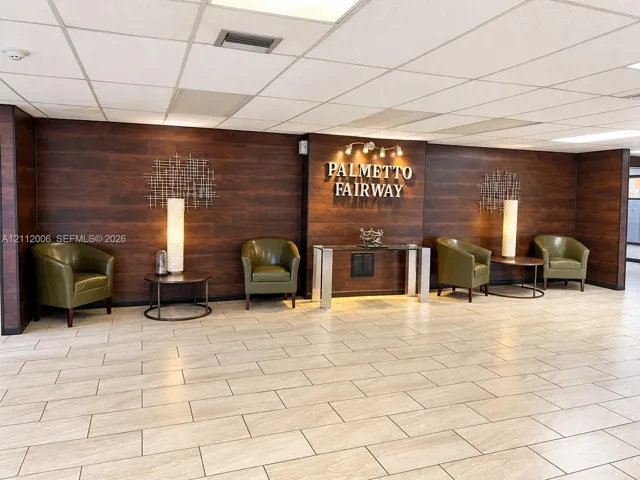 Lobby featuring dark wood-finish wall paneling and tile flooring