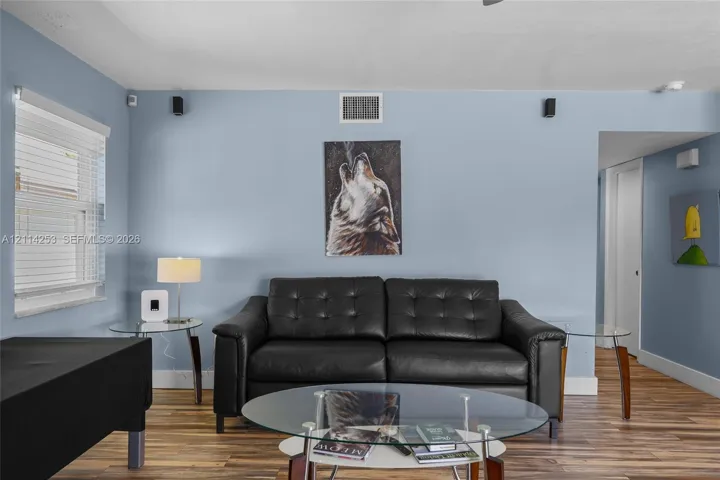 Wood-finish flooring and dual wall-mounted speakers