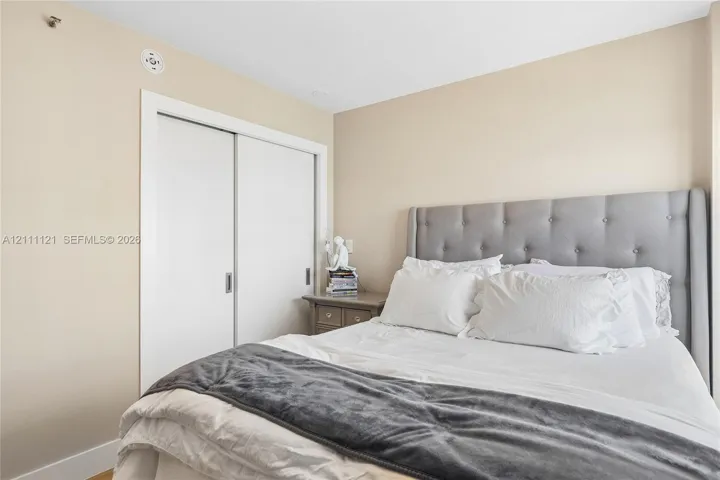 Neutral wall finishes and a built-in closet with sliding doors