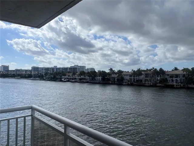 Waterfront balcony featuring a white metal railing and direct exposure to a waterway