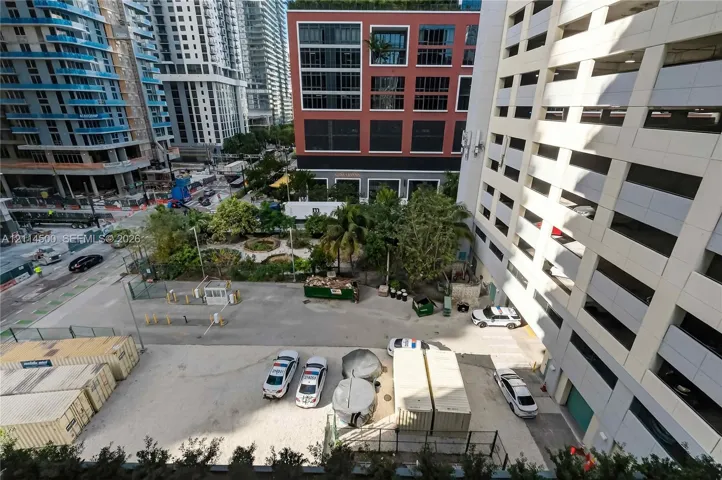 Urban outdoor space featuring mature palm trees and landscaped green areas